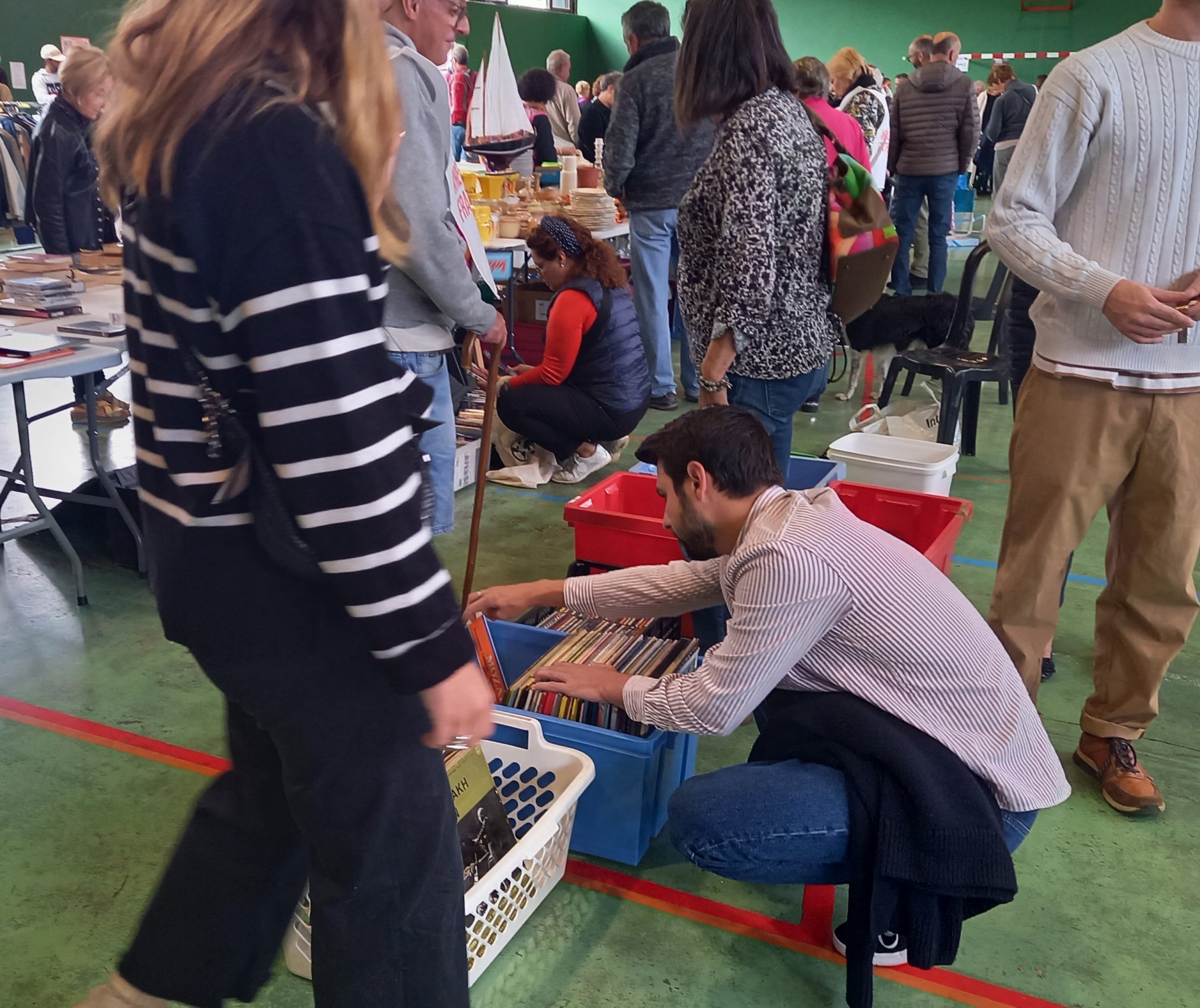 Un monsieur cherche dans une caisse de vinyles